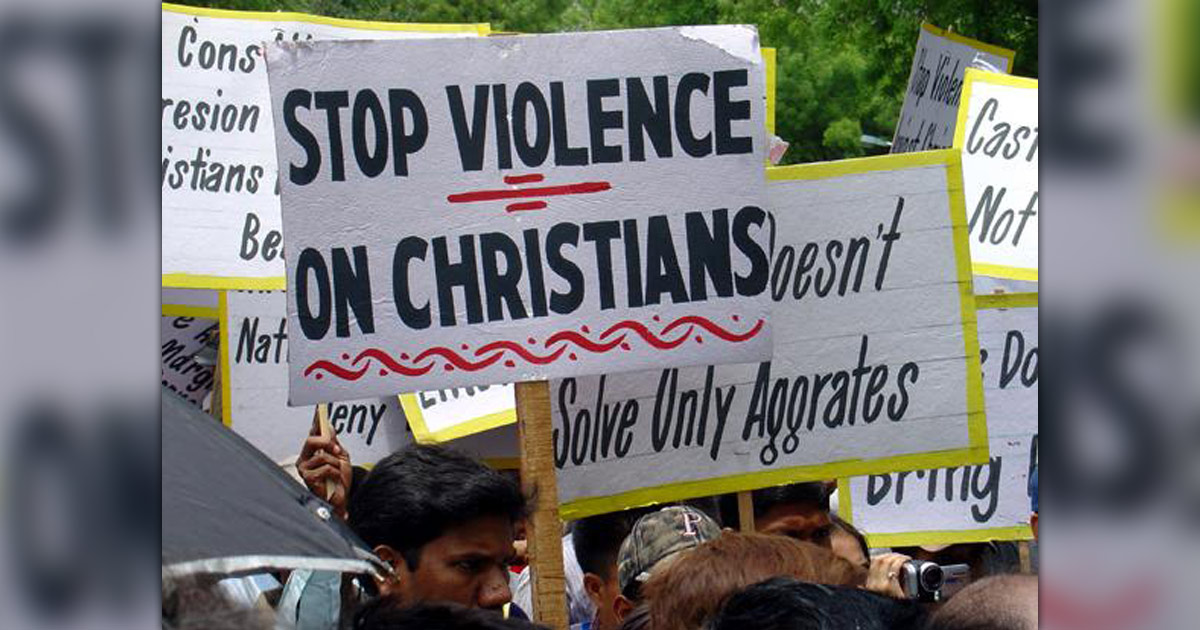 Several people are holding signs protesting violence against Christians.
